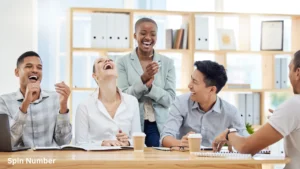 A group of diverse corporate colleagues laughing hysterically around a conference table during a meeting, showcasing the power of ice breaker questions.