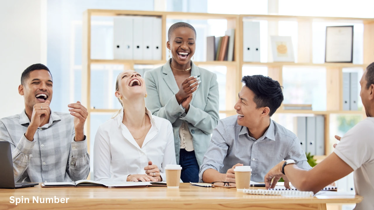 A group of diverse corporate colleagues laughing hysterically around a conference table during a meeting, showcasing the power of ice breaker questions.