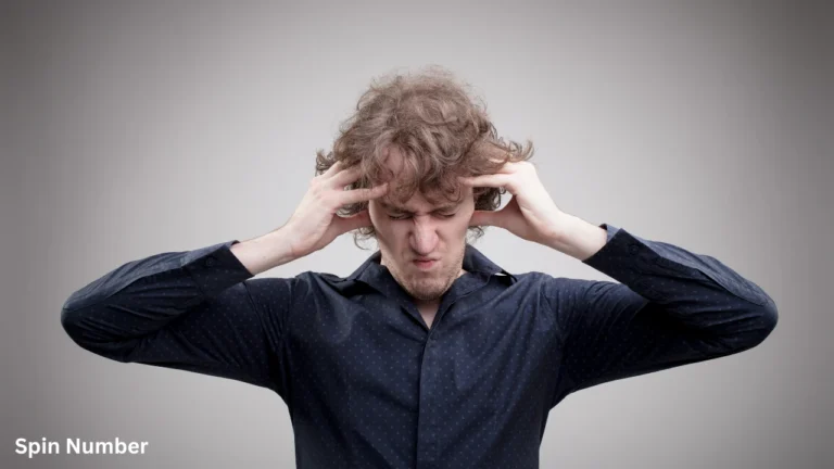 A man clutching his head in frustration with his eyes tightly shut, demonstrating the intense stress of mental looping before learning How to Stop Overthinking.