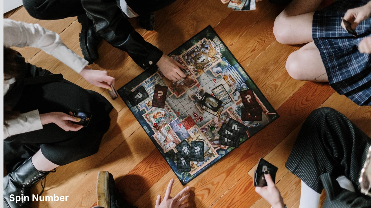 Friends sitting on a wooden floor around a mystery board game, drawing cards that resemble game prompts like Pictionary Words.