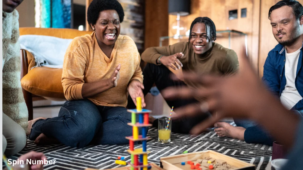A group of friends laughing and playing a tabletop stacking game, perfect inspiration for fun Would You Rather Questions.