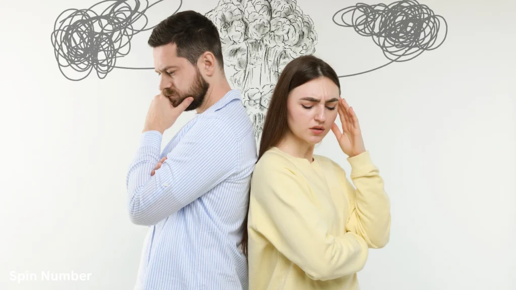 A frustrated man and woman standing back-to-back with thought-bubble doodles of scribbles and an explosion above them, highlighting difficult relationship moments that need therapeutic Questions for Couples.