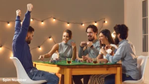 A group of friends celebrating around a table during a competitive card game night with string lights, capturing the tension of fast-paced Minute to Win It Games.