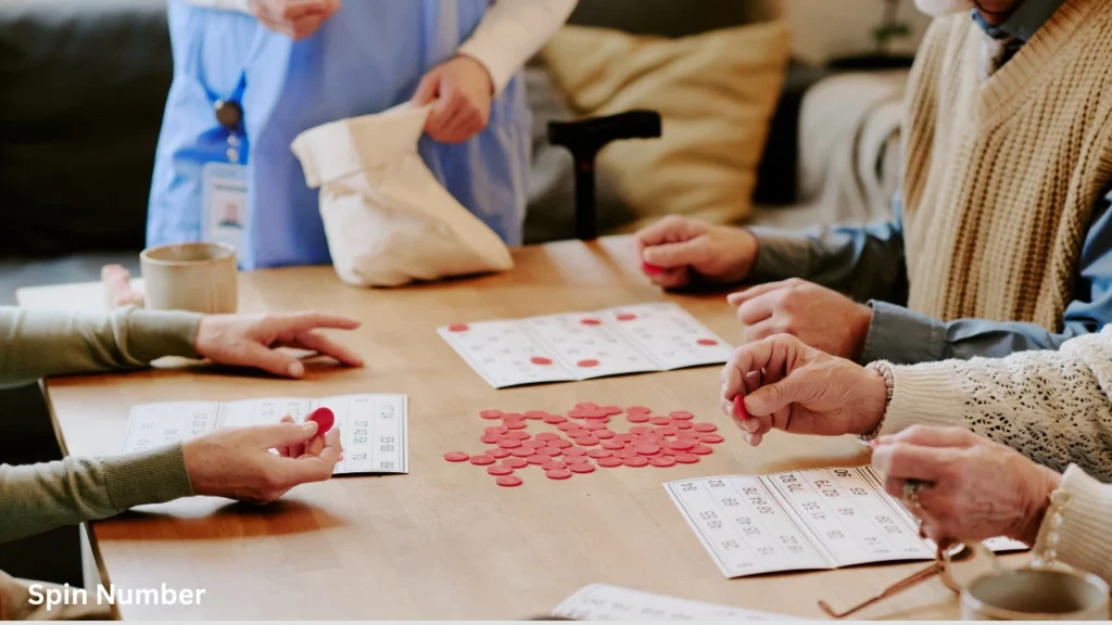 Senior citizens playing a tabletop game with red tokens, practicing cognitive focus similar to guessing hard Pictionary Words.